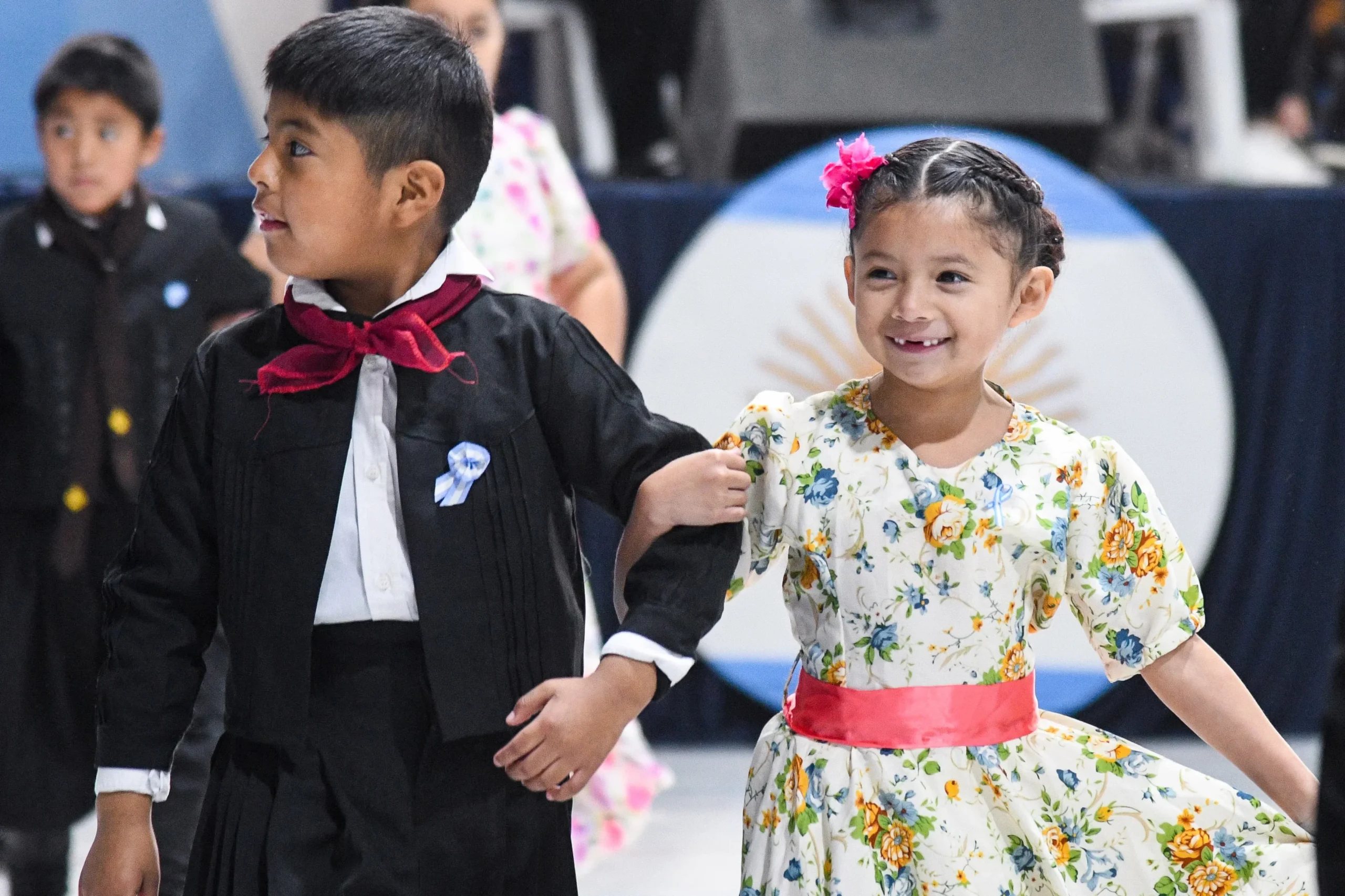 Niños con trajes típicos de folclore argentino bailando en la quinta Peña Patria de la escuela El Pampero.