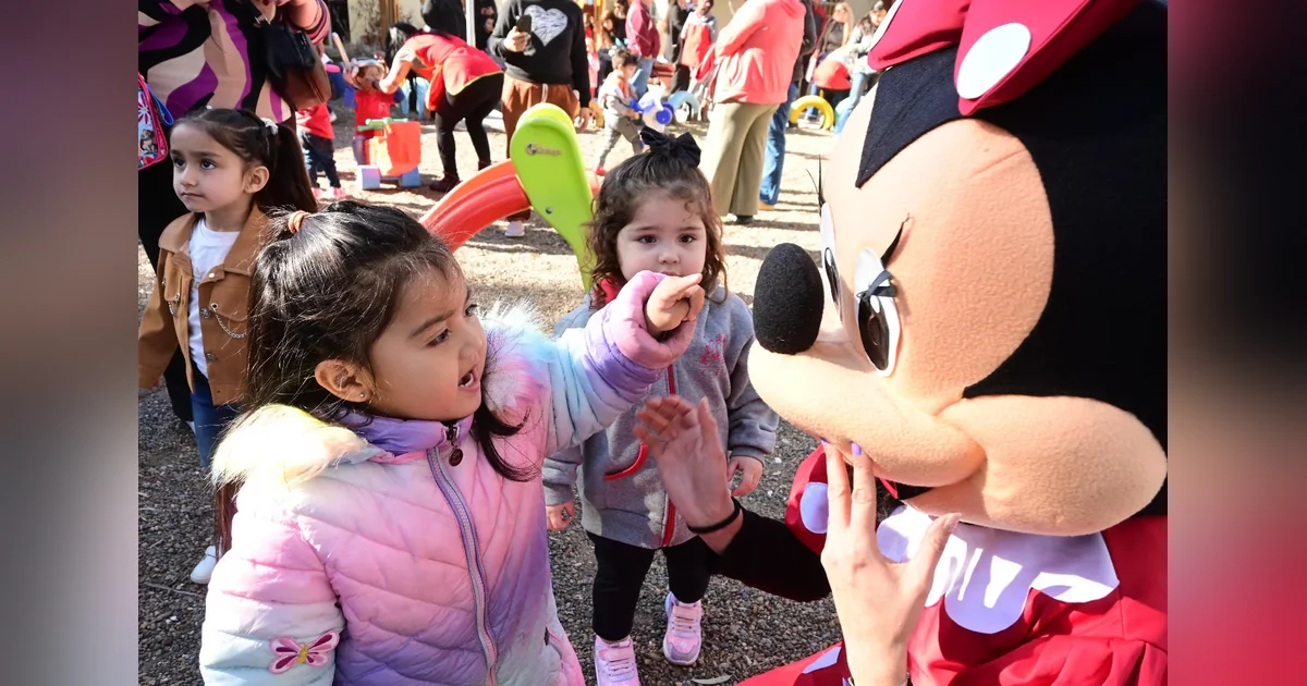 Puerto Madryn: Destacan la importancia de acompañar y cuidar a las infancias Niñas interactúan con una persona disfrazada de Minnie Mouse durante actividades por el Día de la Infancia en Puerto Madryn.