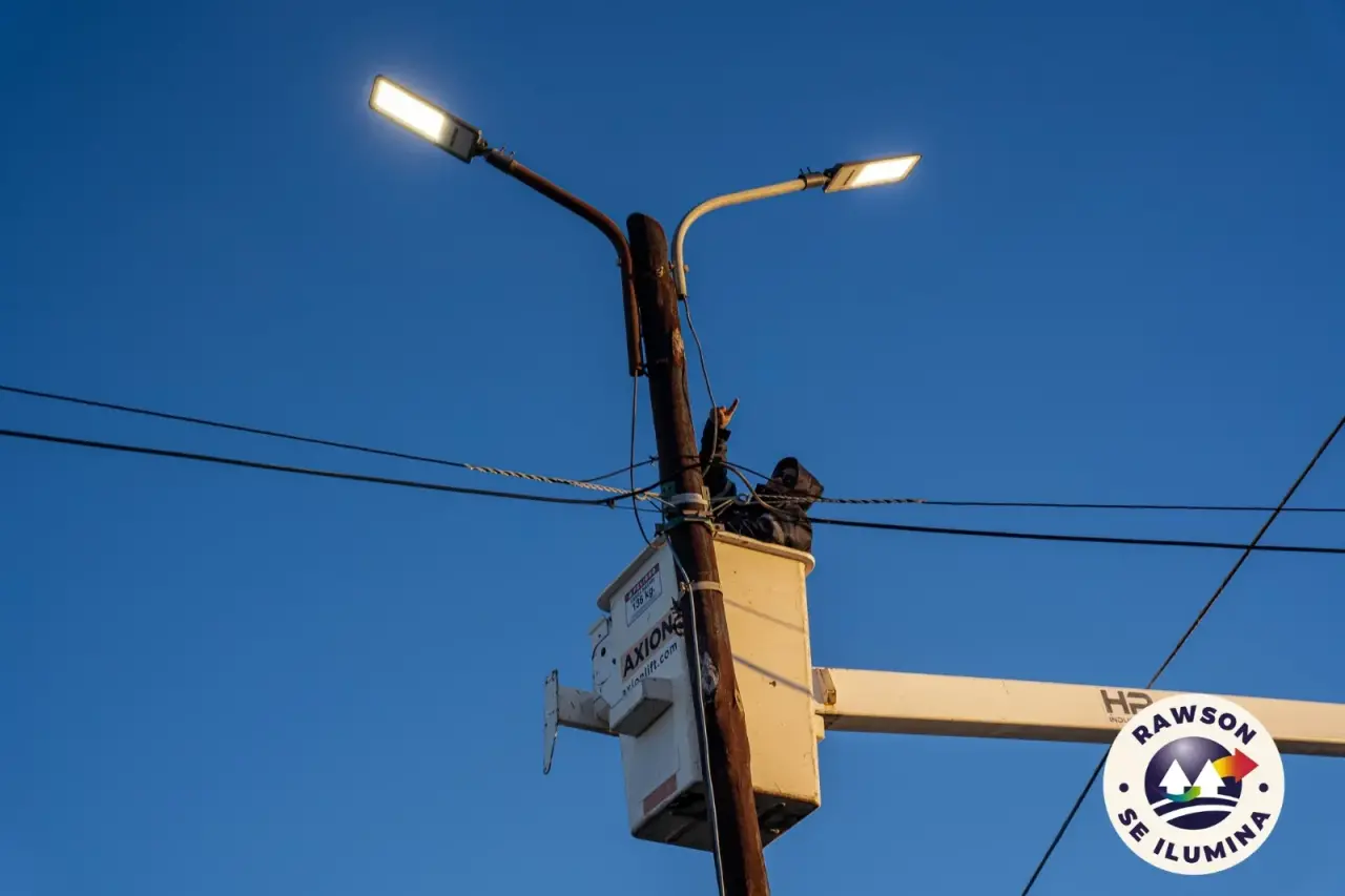 Operario de la Cooperativa de Rawson sobre una plataforma elevadora instalando luminarias LED en la Av. Brown.