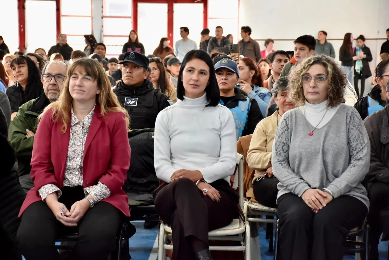 Asistentes y autoridades sentadas en el gimnasio durante el acto por los 20 años de la Escuela N.º 787 en Trelew.